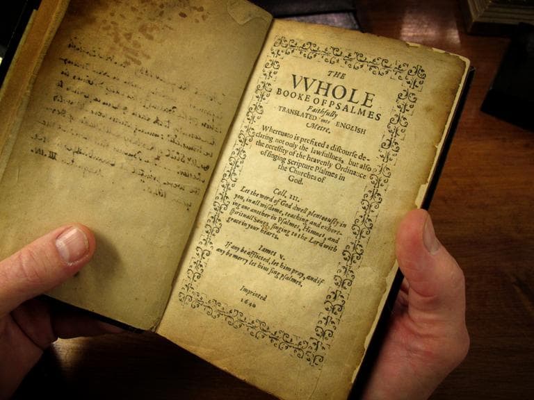 Old South Church is considering selling one of its two copies of the rarest book in the world, the Bay Psalm Book, pictured above in the hands of church historian Jeff Makholm. (Monica Brady-Myerov/WBUR)