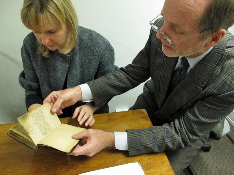 Old South Church historian, who is opposed to the sale, flips through the Bay Psalm Book with WBUR reporter Monica Brady-Myerov. 