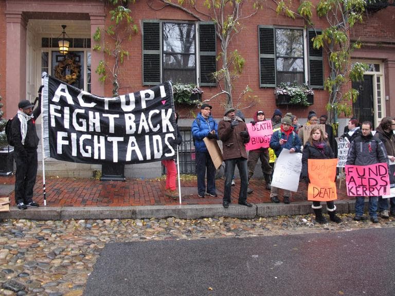 Members of the AIDS advocacy group ACT UP Boston demonstrate outside U.S. Sen. John Kerry's Beacon Hill home on Saturday. (Eric DelGizzo/WBUR)
