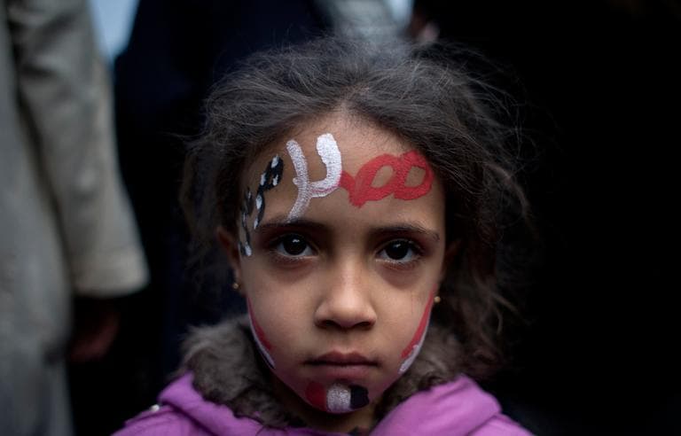 A girl with the colors of Egypt's national flag and Arabic that reads, "Egypt, Morsi," painted on her face attends a demonstration in front of Egypt’s top court, in Cairo, Egypt on Sunday. (Nasser Nasser/AP)