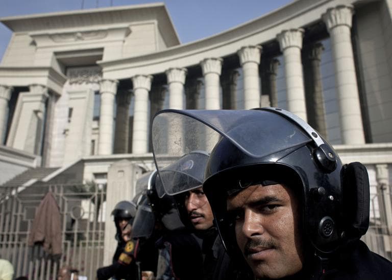 Riot policemen stand guard in front of Egypt's top court during a protest for supporters of Egyptian President Mohammed Morsi in Cairo, Egypt, Monday, Dec. 3, 2012. (Nasser Nasser/AP)