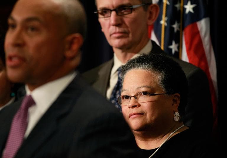Health and Human Services Secretary JudyAnn Bigby, below right, looks on as Gov. Deval Patrick faces reporters at the State House Thursday. John Polanowicz, who is Patrick's pick to replace Bigby, looks on. (Steven Senne/AP)