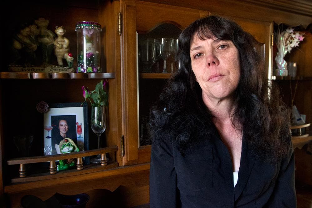 Kim Flynn, with a photo of her daughter, Stephanie Moulton, a group home worker who was allegedly killed by a client with a long history of violence (Jesse Costa/WBUR)