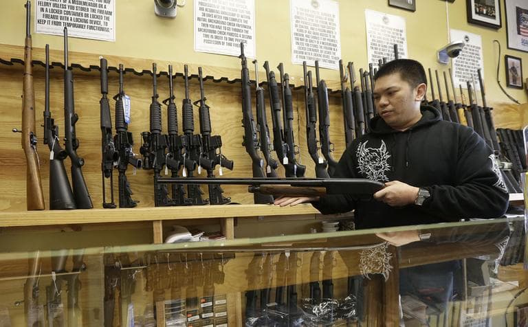 General manager Steve Alcairo holds a Winchester 1200 shotgun while being interviewed at High Bridge Arms Inc. in San Francisco on Wednesday. (Jeff Chiu/AP)