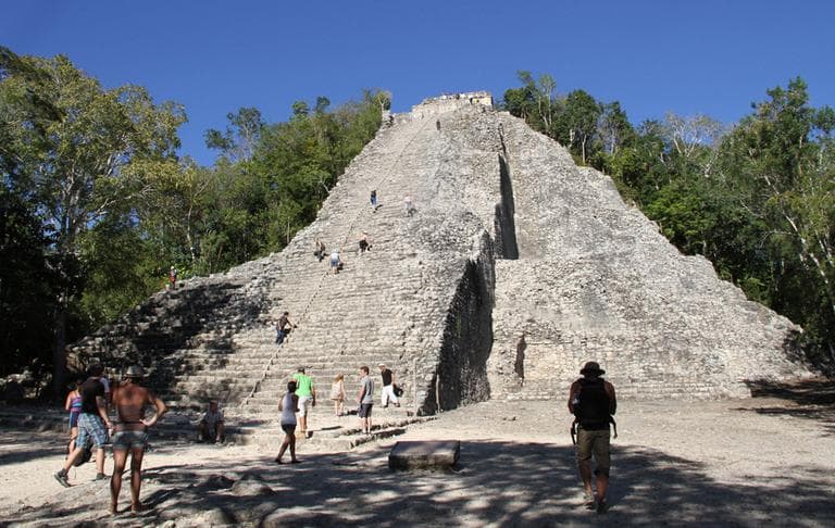 In this Saturday, Dec. 15, 2012 photo, tourists climb the pyramid at the archeological site in Coba, Mexico. Amid a worldwide frenzy of advertisers and new-agers preparing for a Maya apocalypse, one group is approaching Dec. 21 with calm and equanimity: the people whose ancestors supposedly made the prediction in the first place. (Israel Leal/AP)