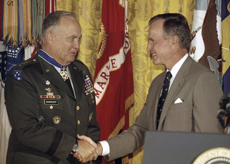In this July 4, 1991 file photo, President George Bush congratulates Desert Storm commander Gen. Norman Schwarzkopf after presenting him with the medal of freedom at the White House in Washington. (Doug Mills/AP)