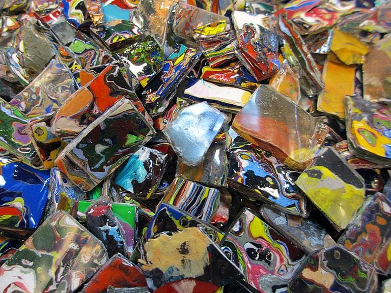 The centerpiece of some Artists for Humanity jewelry: students chip old paint off used palettes, dip the paint in eco-friendly resin, and chop the material into smaller pieces to create earrings, bracelets and necklaces. (Kathleen McNerney/WBUR)