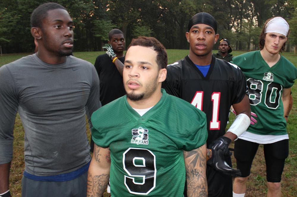 Players on the North Jersey Spartans football team gather during practice. Coach Kevin Moss started the team to encourage players to stay in school. (Dave Grunebaum/OAG)