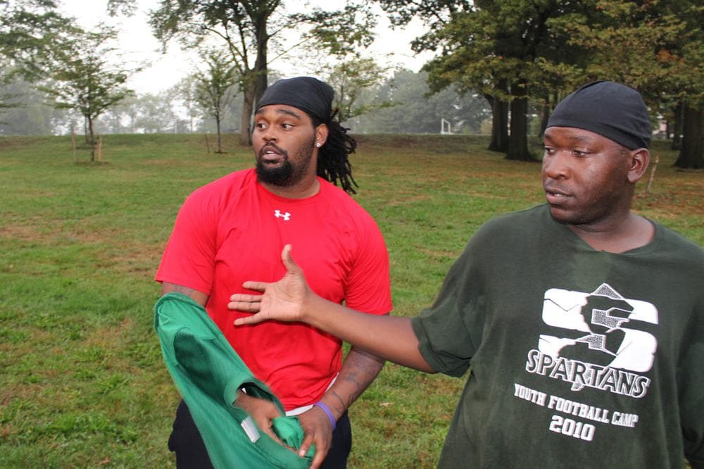 Justin Sessoms, left, stands with coach Kevin Moss during a practice. (Dave Grunebaum/OAG)