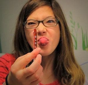 Riley Cerabona expresses her feelings about the taste of sirolimus (Jesse Costa/WBUR)