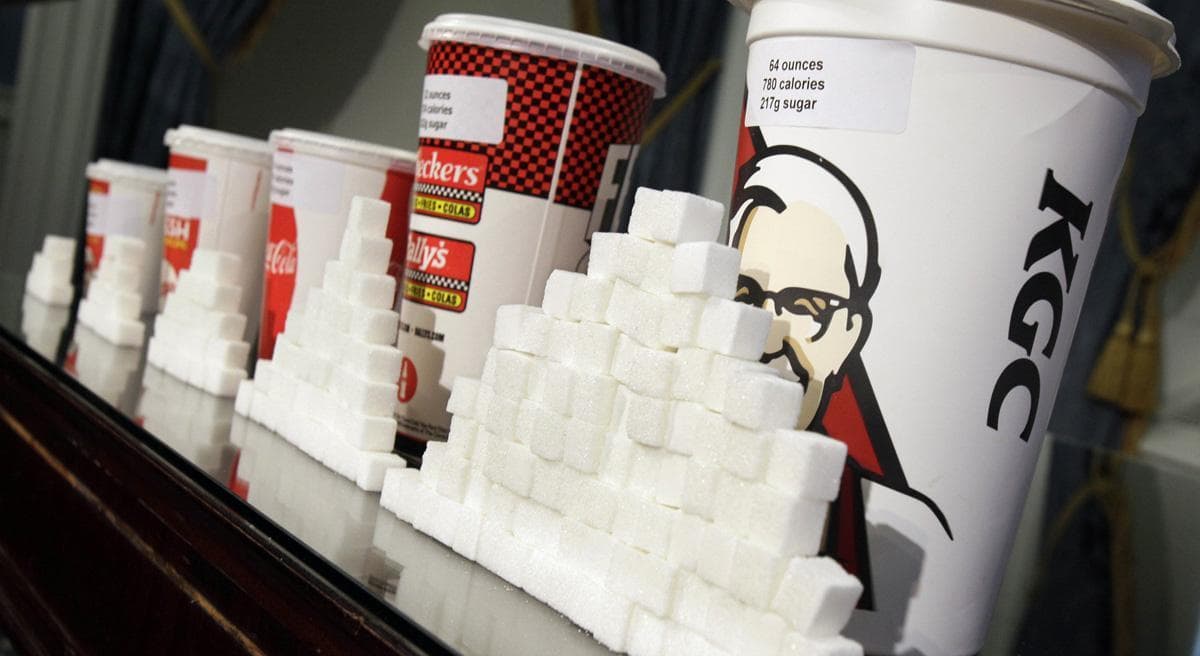 This Thursday, May 31, 2012 photo shows a display of various size soft drink cups next to stacks of sugar cubes at a news conference at New York's City Hall. Research greatly strengthens the case against soda and other sugary drinks as culprits in the obesity epidemic. (Richard Drew/AP)