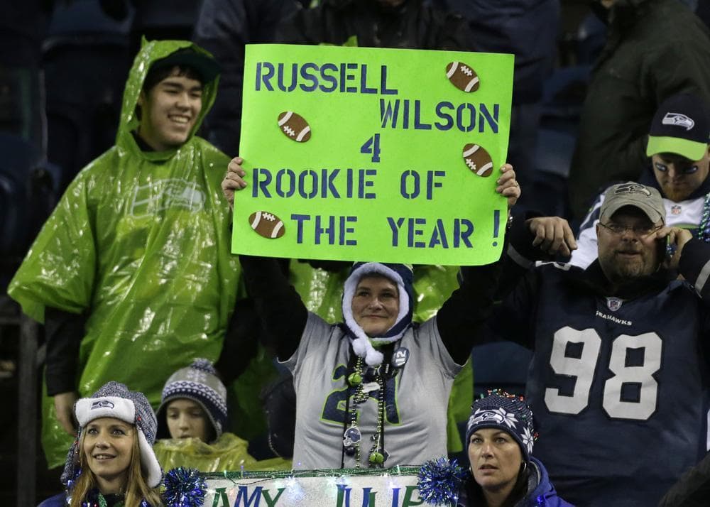 Fans in Seattle are hopeful about the Seahawks' postseason prospects behind quarterback Russell Wilson. (Elaine Thompson/AP)