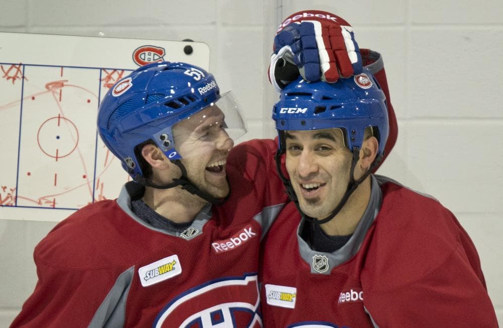 The Montreal Canadiens' David Desharnais, left, and Scott Gomez aren't the only ones smiling these days. NHL fans will see their teams on the ice again now that the lockout has come to an end. (Paul Chiasson, The Canadian Press/AP)
