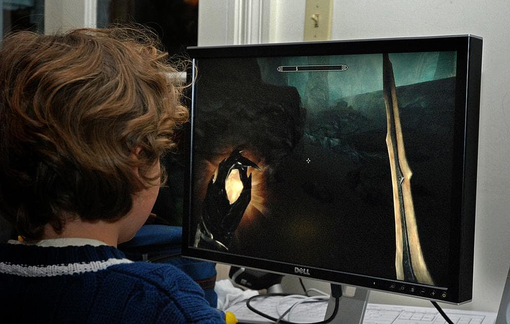 Carey's 8-year-old son Tully plays the game "Skyrim" on their family computer. (George Hicks/WBUR)