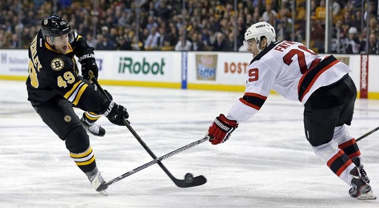 Bruins center Rich Peverley (49) shoots as New Jersey Devils defenseman Mark Fayne (29) tries to block. (AP/Charles Krupa)