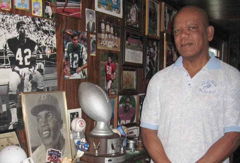 On Wednesday, Butch Byrd stands in front of memorabilia in his Westborough home. (Lynn Jolicoeur/WBUR)