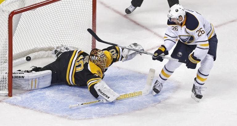 Buffalo Sabres left wing Thomas Vanek pokes the puck past Bruins goalie Tuukka Rask during the third period Thursday night. (Charles Krupa/AP)