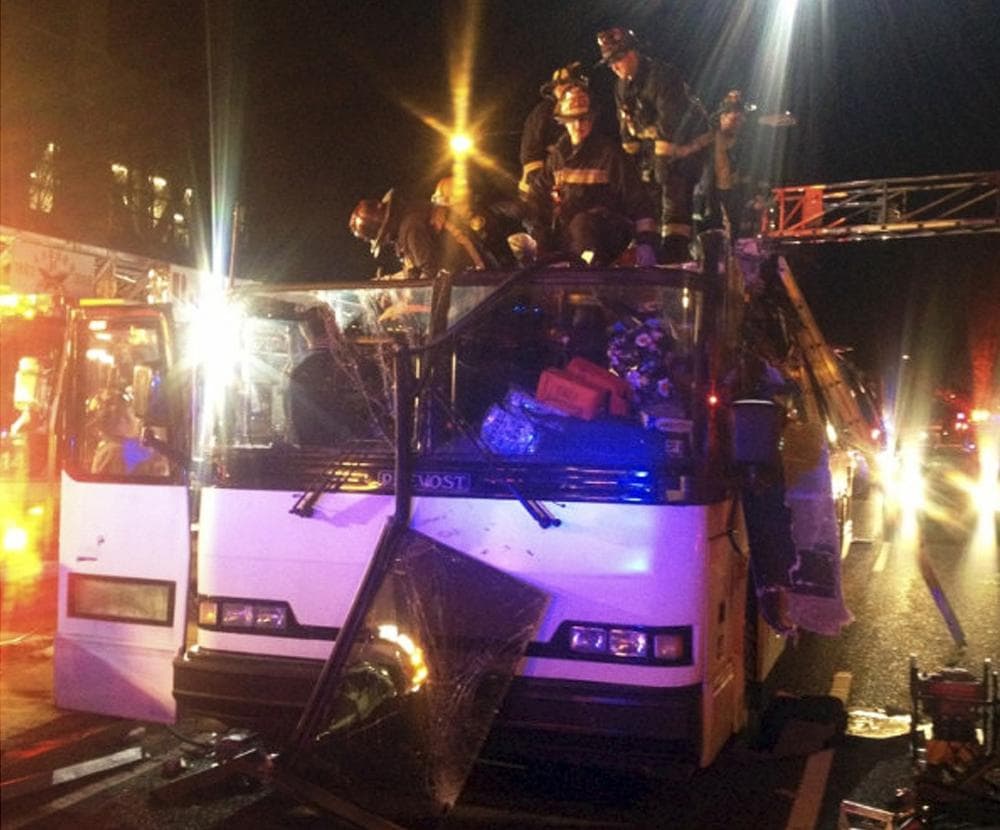 In this photo released by the Boston Fire Department via Twitter, firemen work to remove injured passengers from a bus that hit an bridge as it traveled along Soldiers Field Road in the Allston neighborhood of Boston Saturday night, Feb. 2, 2013. (Boston Fire Department/AP)