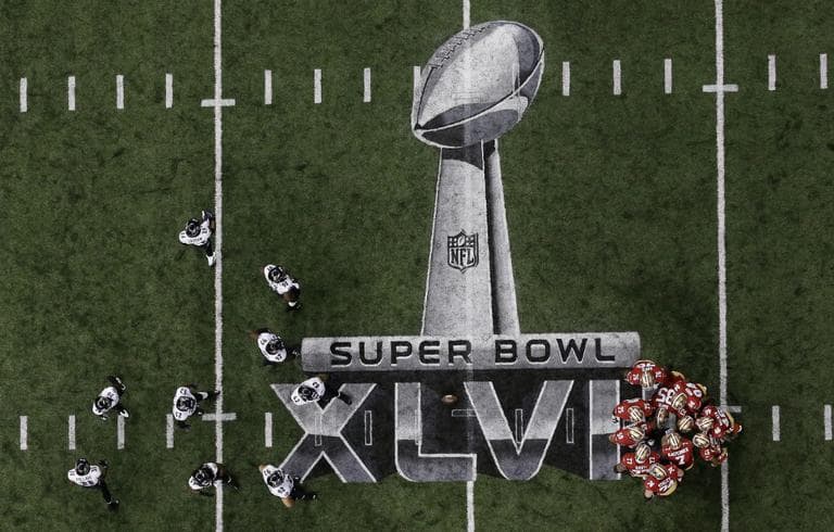 The San Francisco 49ers and the Baltimore Ravens huddle on the field during the first half of the NFL Super Bowl XLVII football game, Sunday, Feb. 3, 2013, in New Orleans. (Tim Donnelly/AP)