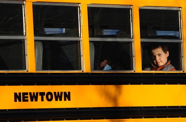 A boy sits on a Newtown bus leaving the new Sandy Hook Elementary School after the first day of classes in Monroe, Conn., Thursday, Jan. 3, 2013. The former Chalk Hill School was renamed Sandy Hook Elementary and overhauled especially for the students from the Sandy Hook School shooting. (Jessica Hill/AP)