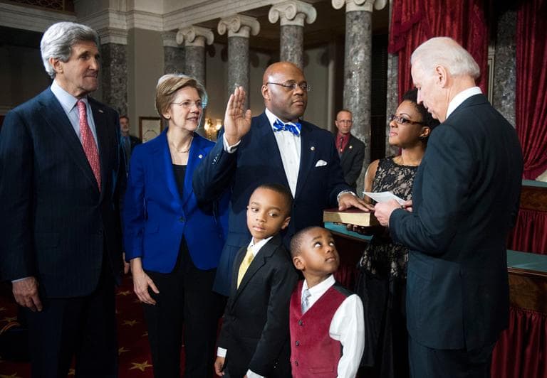 Vice President Joe Biden re-enacts administering the Senate oath to Sen. William "Mo" Cowan Thursday on Capitol Hill. Joining him, from left: Secretary of State John Kerry, Sen. Elizabeth Warren, his sons Miles, 8, and Grant 4, and his wife Stacey. (Kevin Wolf/AP)