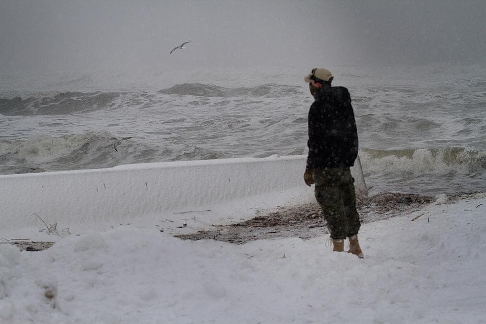 Watching the waves crushing in Hull, Mass. (Jesse Costa/WBUR)