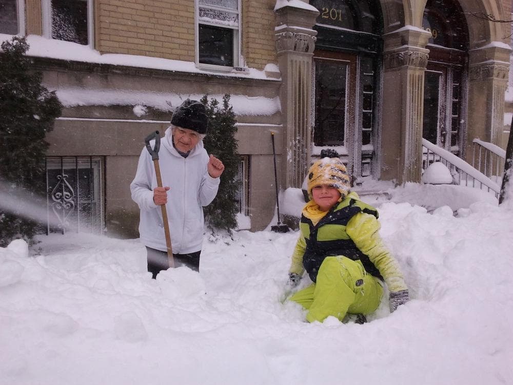 Shoveling snow in Brookline on Saturday morning. (Aayesha Siddiqui/WBUR)