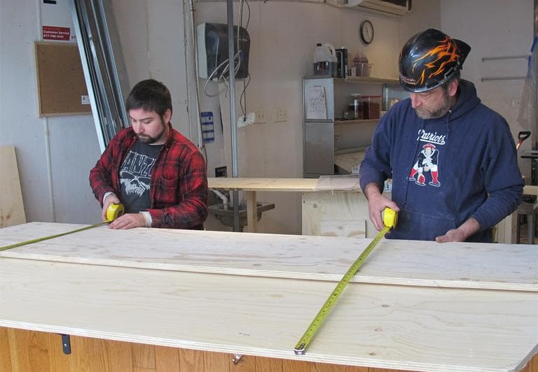 Workers redesign the former Upper Crust pizzeria in Harvard Square (Curt Nickisch/WBUR)