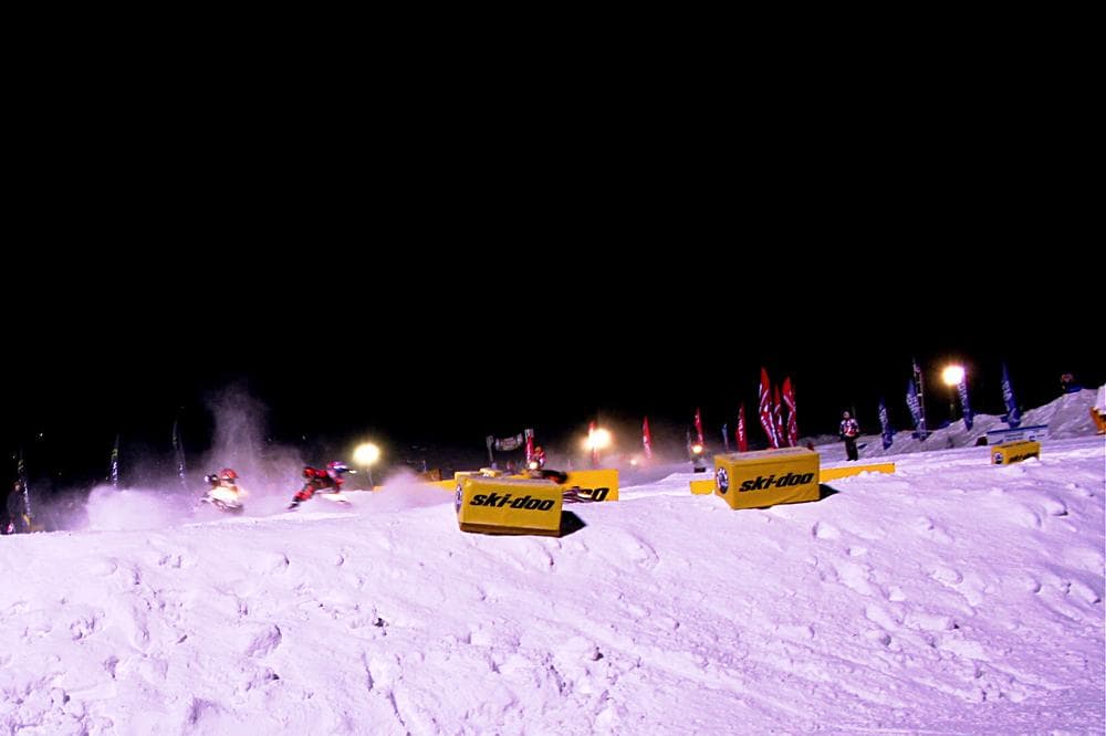 Snowmobile racers enter a sharp turn at a competition in Michigan last weekend. (Neal Steeno/Only A Game)