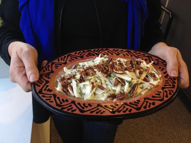 Kathy Gunst holds a dish of her Fennel and Celery Root Slaw. (Rachel Rohr/Here &amp; Now)