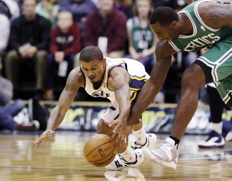 Utah's Earl Watson and Boston's Brandon Bass chase after a loose ball in the first quarter. (AP)