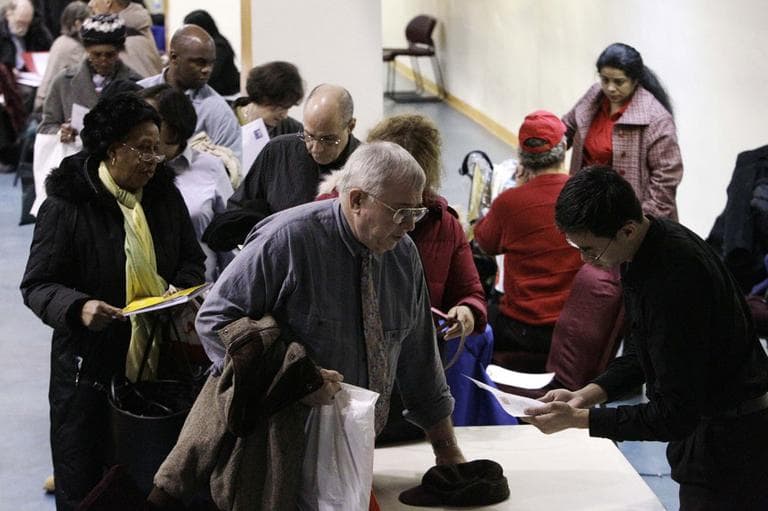 In this Jan. 18, 2011 file photo, John Pham, right, a program officer with Reserve Inc., reviews the resume of Bob Drake, 63, at an AARP Career event aimed at helping older workers improve their job search, in New York. (AP)
