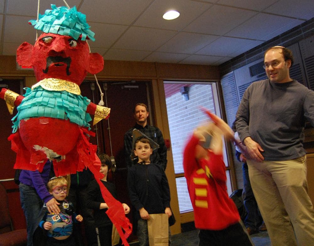 Kobe Richberg bashes the Haman piñata during Temple Shalom's Purim Party. (Greg Cook)