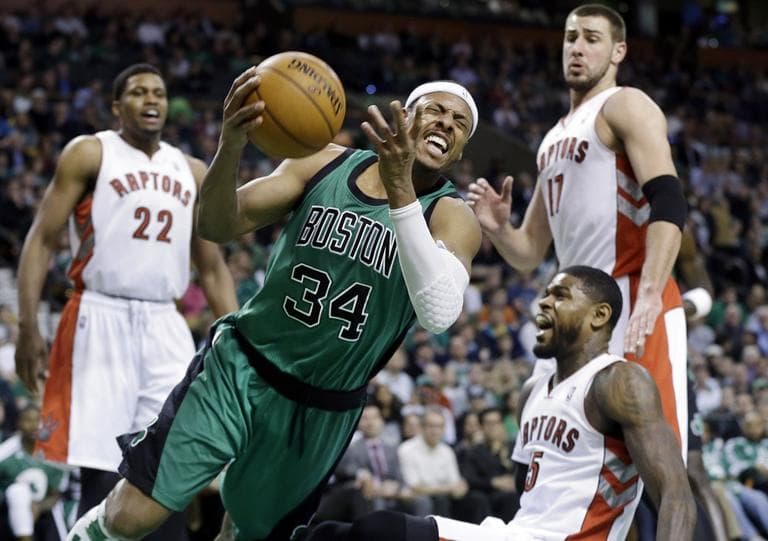 Boston Celtics forward Paul Pierce (34) drives Toronto Raptors forward Rudy Gay (22), center Jonas Valanciunas (17) and forward Amir Johnson (15). (AP/Elise Amendola)