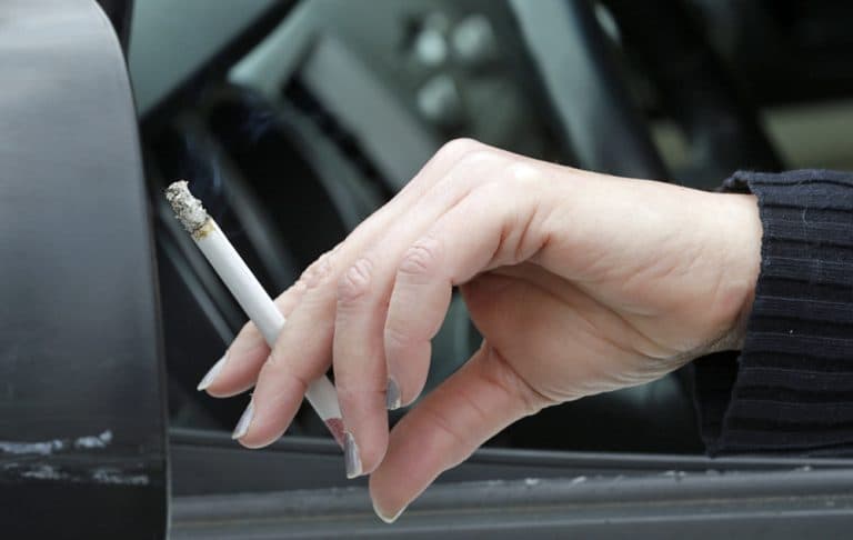 In this March 2 photo, a woman smokes a cigarette while sitting in her truck in Hayneville, Ala. (AP)