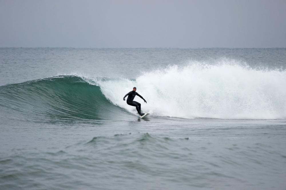 University of Minnesota Duluth journalism professor John Hatcher surfing Lake Superior in 2012. (Bob Tema)