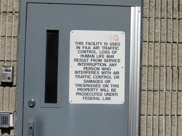 A warning sign on the door of the air traffic control tower at Norwood Memorial Airport. (Bruce Gellerman/WBUR)