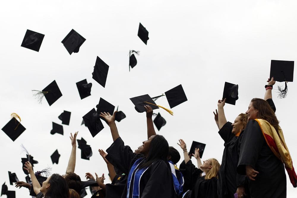 Graduates from various institutions toss their hats in the air in Philadelphia, May 20, 2011. (Matt Rourke/AP)