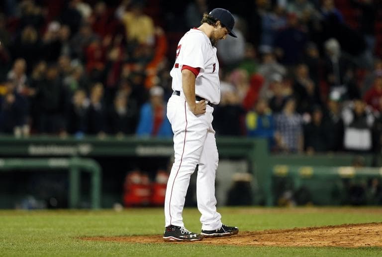 Red Sox's Joel Hanrahan looks down after giving up a 3-run home run to Baltimore Orioles' Manny Machado in the ninth inning. (AP/Michael Dwyer)
