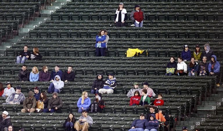 Scattered fans sit in the bleachers at Fenway in the eighth inning of a game against the Orioles Wednesday night. The Red Sox officially announced that their nearly 10-year streak of home sellouts had ended. (Michael Dwyer/AP)