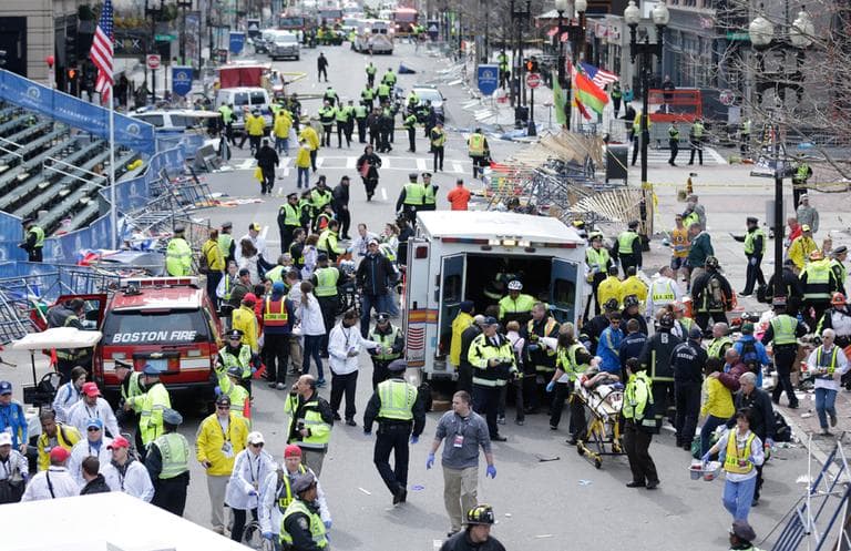 Medical workers aid injured people at the finish line of the 2013 Boston Marathon following an explosion in Boston, Monday, April 15, 2013. (Charles Krupa/AP)