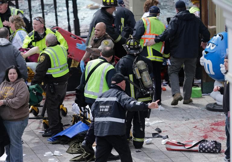 Medical workers aid injured people at the finish line of the 2013 Boston Marathon following an explosion in Boston, Monday, April 15, 2013. (Charles Krupa/AP)