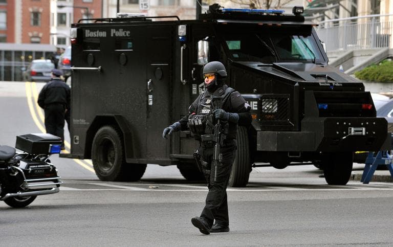 A Boston police officer patrols the area near the finish line following an explosion at the 2013 Boston Marathon in Boston, Monday, April 15, 2013. (Josh Reynolds/WBUR)