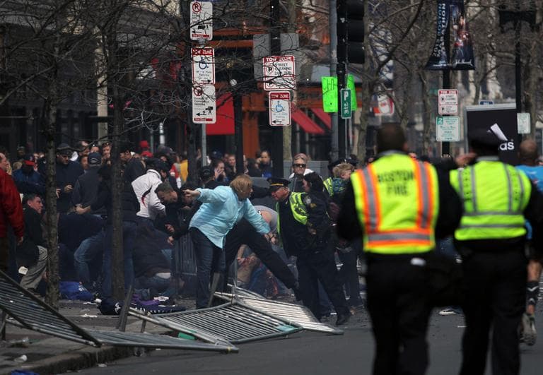 In this photo provided by The Daily Free Press and Kenshin Okubo, people react to an explosion at the 2013 Boston Marathon in Boston, Monday, April 15, 2013. (The Daily Free Press, Kenshin Okubo/AP)