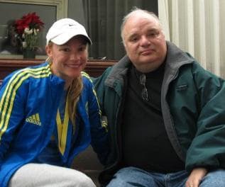 Rebecca Roche with WBUR's Bob Oakes after finding out her mother's knee surgery went well. Sixty-year-old Beth Roche was injured in one of the explosions near the Boston Marathon finish line on Monday. (Kathleen McNerney/WBUR)