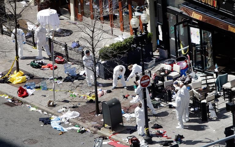 Investigators in haz-mat suits.