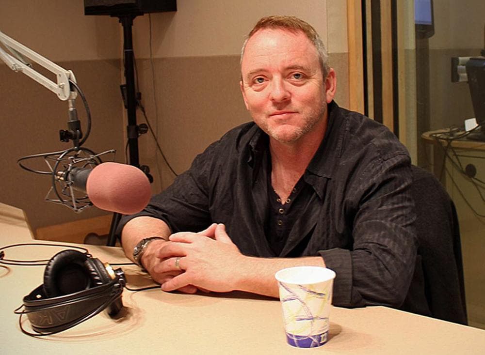 Author Dennis Lehane in the On Point studio with Tom Ashbrook on April 18, 2013. (Alex Kingsbury/WBUR)