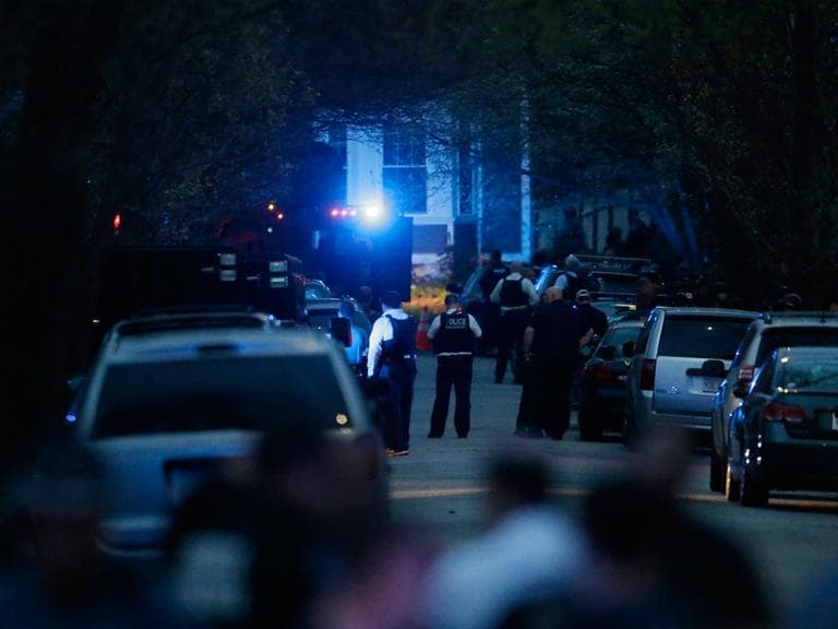 Law enforcement search for the suspect in the Boston Marathon bombings, Friday, April 19, 2013, in Watertown, Mass. Gunfire erupted Friday night amid the manhunt for the surviving suspect in the Boston Marathon bombing, and police in armored vehicles and tactical gear rushed into the Watertown neighborhood in a possible break in the case. (Matt Rourke/AP)