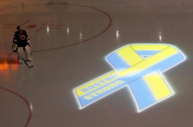 Boston Bruins goalie Tuukka Rask, of Finliand, looks up to the video screen as a tribute to local law enforcement is played before the start of an NHL hockey game against the Pittsburgh Penguins, Saturday, April 20, 2013, in Boston. (Mary Schwalm/AP)
