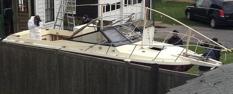 Investigators work near the location, on Saturday, April 20, 2013, in Watertown, Mass., where the previous night a suspect in the Boston Marathon bombings was arrested. (Katie Zezima/AP)
